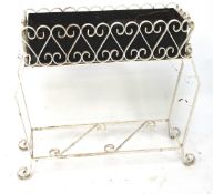 A white painted metal plant stand with scrollwork, with liner.