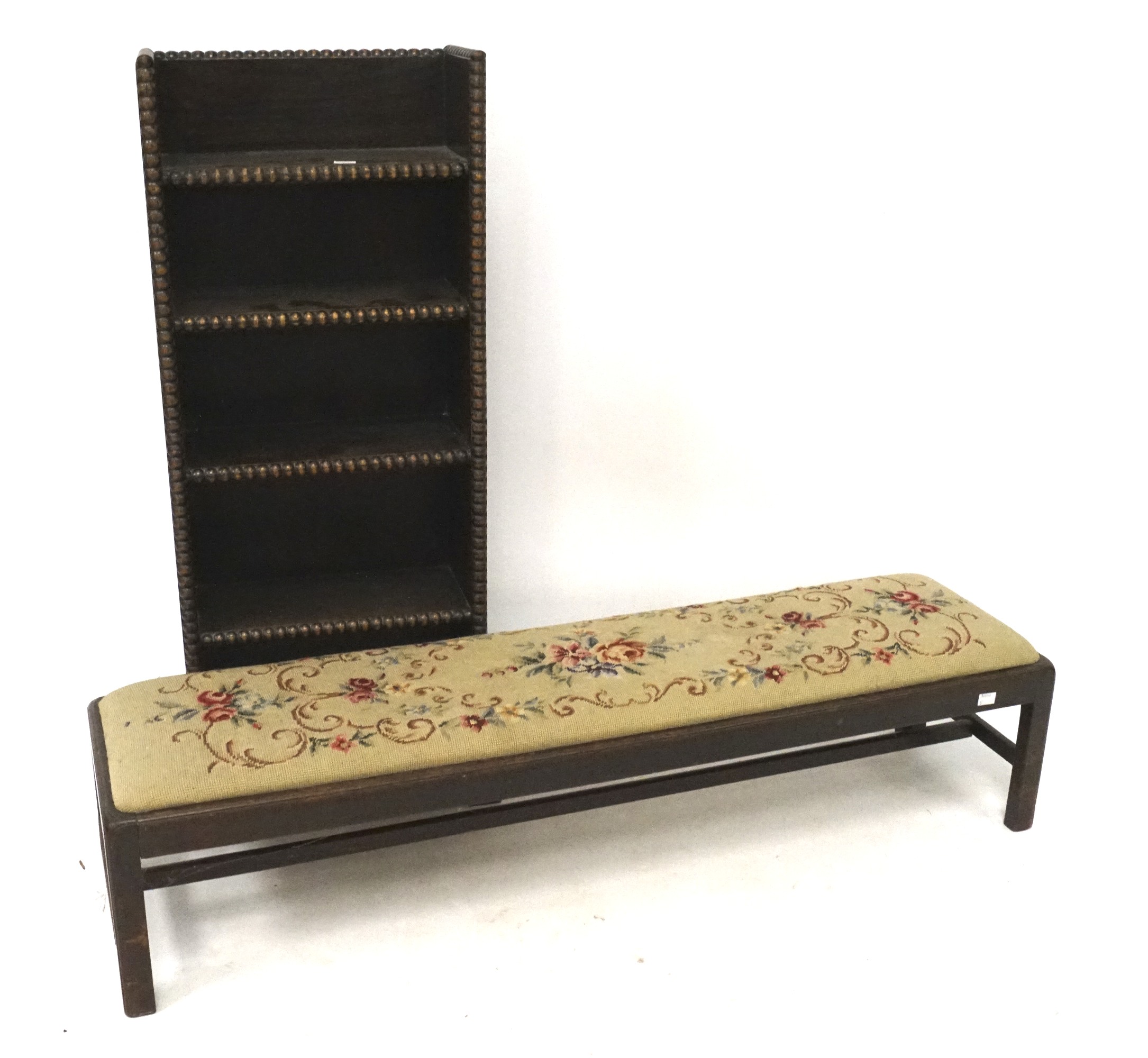 A free standing oak bookcase with beaded edges and a long bench with tapestry drop in seat.