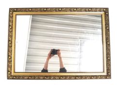 A gilt framed wall mirror.