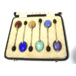 A boxed set of six Edwardian silver and enamel teaspoons.