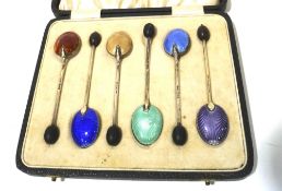 A boxed set of six Edwardian silver and enamel teaspoons.