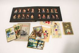 An assortment of early cigarette cards and postcards.