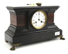 A late 19th century French slate and stone set mantel clock.