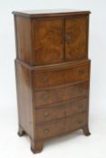 A mid-20th century bow fronted burr walnut cabinet marked 'Cameo'.