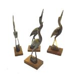 Four carved horn figures of cranes.