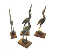 Four carved horn figures of cranes.