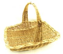 A wicker basket with a single handle, L58cm.