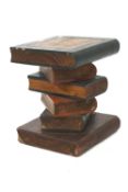 A part stained oak occasional table. Carved of separate pieces to form a pile of books.