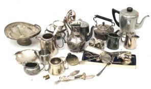 A collection of silver plated and metal kitchen items. Including teapots, fruit bowl, dishes, etc.
