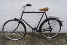 A vintage gents bicycle. In black with brown seat.