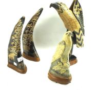 Four carved horns fixed to wooden bases.