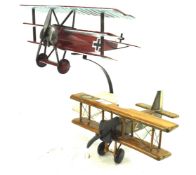 Two painted and varnished wooden models of historic aircraft.