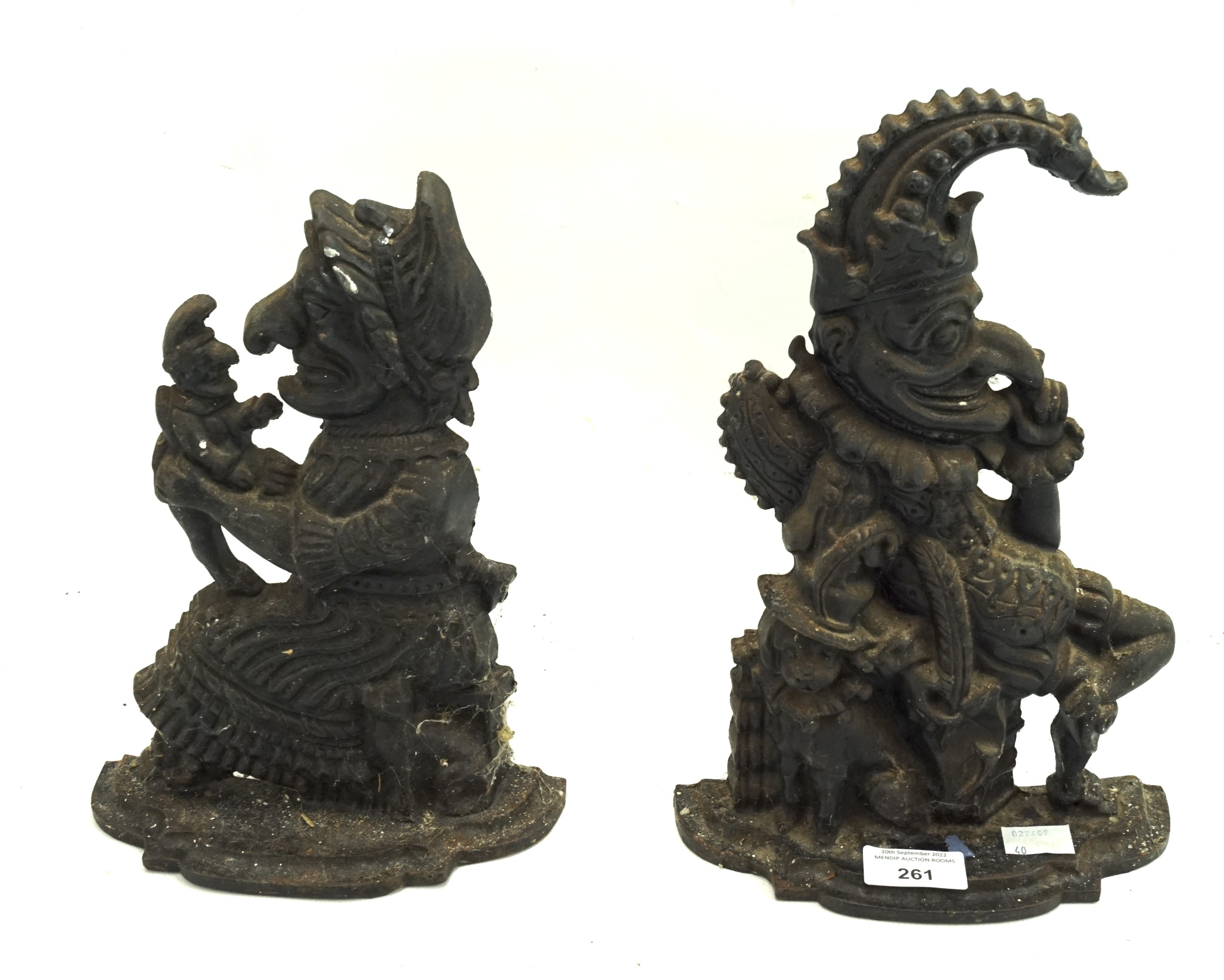 Two cast iron doorstops in the form of Punch and Judy.