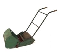 A vintage Webb child's mower, painted green.