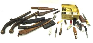 An assortment of knives and replica guns.