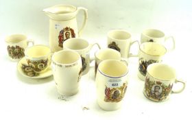 An assortment of commemorative beakers. Including mugs, cup and saucer, and jug.