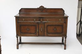 An oak sideboard with beaded decoration.