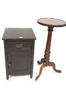A dark stained bedside cabinet and a round mahogany occasional table.