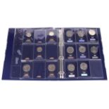 A collection of coins in an album. To include ten £5 coins, five £2 coins, etc.