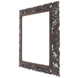 A late 19th/early 20th century carved and stained wood mirror.