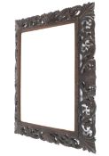 A late 19th/early 20th century carved and stained wood mirror.
