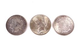 Three USA silver dollars. Three 1921 Morgan dollars and 1922.