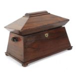 An early 19th century rosewood sarcophagus-shaped tea caddy.