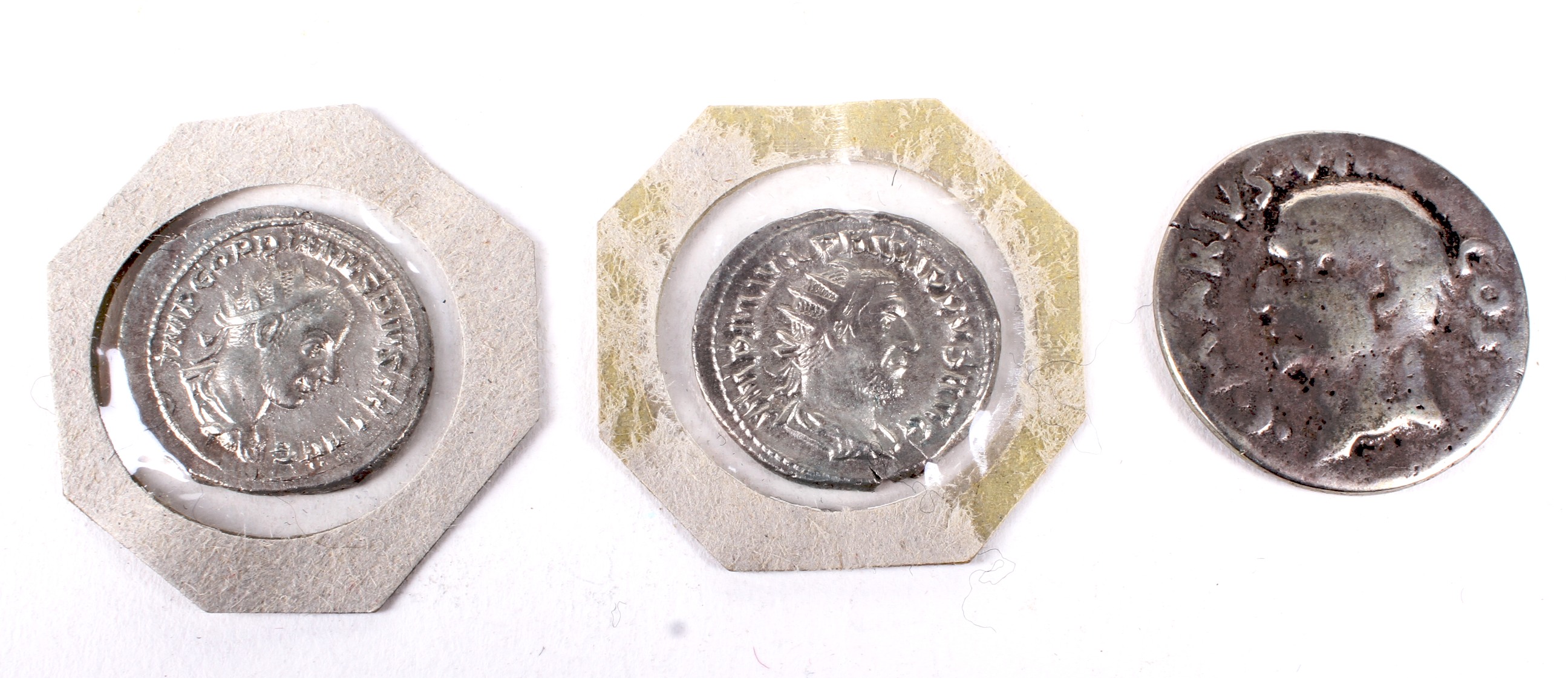 Three Roman silver coins.