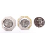 Three Roman silver coins.