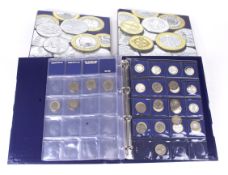 Three coin albums. Including 26 10p alphabet coins, 40 50p coins and 21 £2 coins.