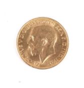 A 1928 full sovereign coin.