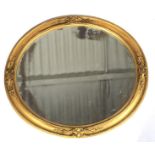 A Victorian gilt framed oval mirror.