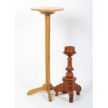 An oak ecclesiastical candle stand and a stained candle holder.