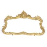 A 19th century giltwood and gesso scroll shaped overmantel mirror.