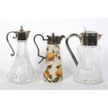 A silver plated glass water jug, a decanter and a ceramic decanter.