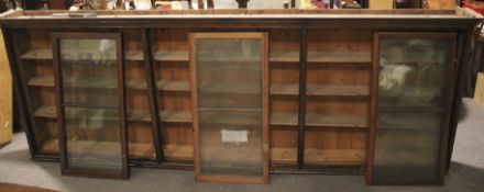 A late 19th century large wall hanging/free standing stained pitch pine bookcase.