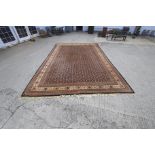 A large room size woollen Persian carpet.