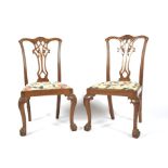 A pair of mahogany Chippendale style dining chairs.