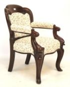 A Victorian mahogany framed button back armchair.