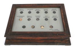 An Edwardian stained wooden Christy Bros (Chelmsford) Servant's bell system.