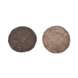 Two hammered penny coins.