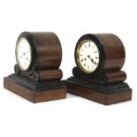 A pair of similar mahogany and ebony Art Deco mantel clocks.