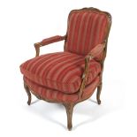 A Contemporary continental style fruitwood framed elbow chair.