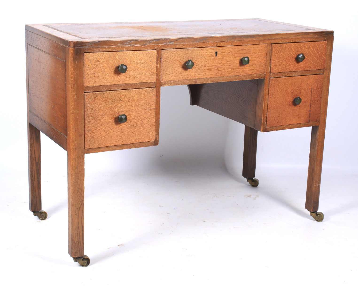 An oak Arts and Crafts kneehole desk.