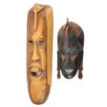 Two mid-century Solomon Island carved wooden masks.