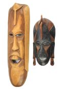 Two mid-century Solomon Island carved wooden masks.