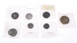 Seven Roman coins, including one silver example.