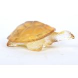 A Lalique amber tinted glass model of a turtle.