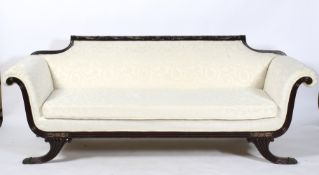 An Edwardian ebonised frame re-upholstered sofa in cream,