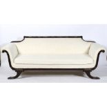 An Edwardian ebonised frame re-upholstered sofa in cream,